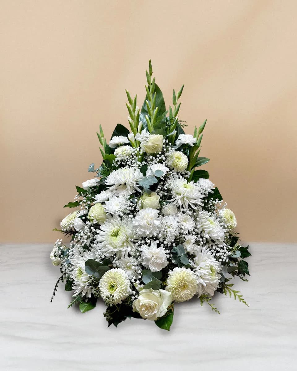 Trauerarrangement aus weissen Blumen und Grün