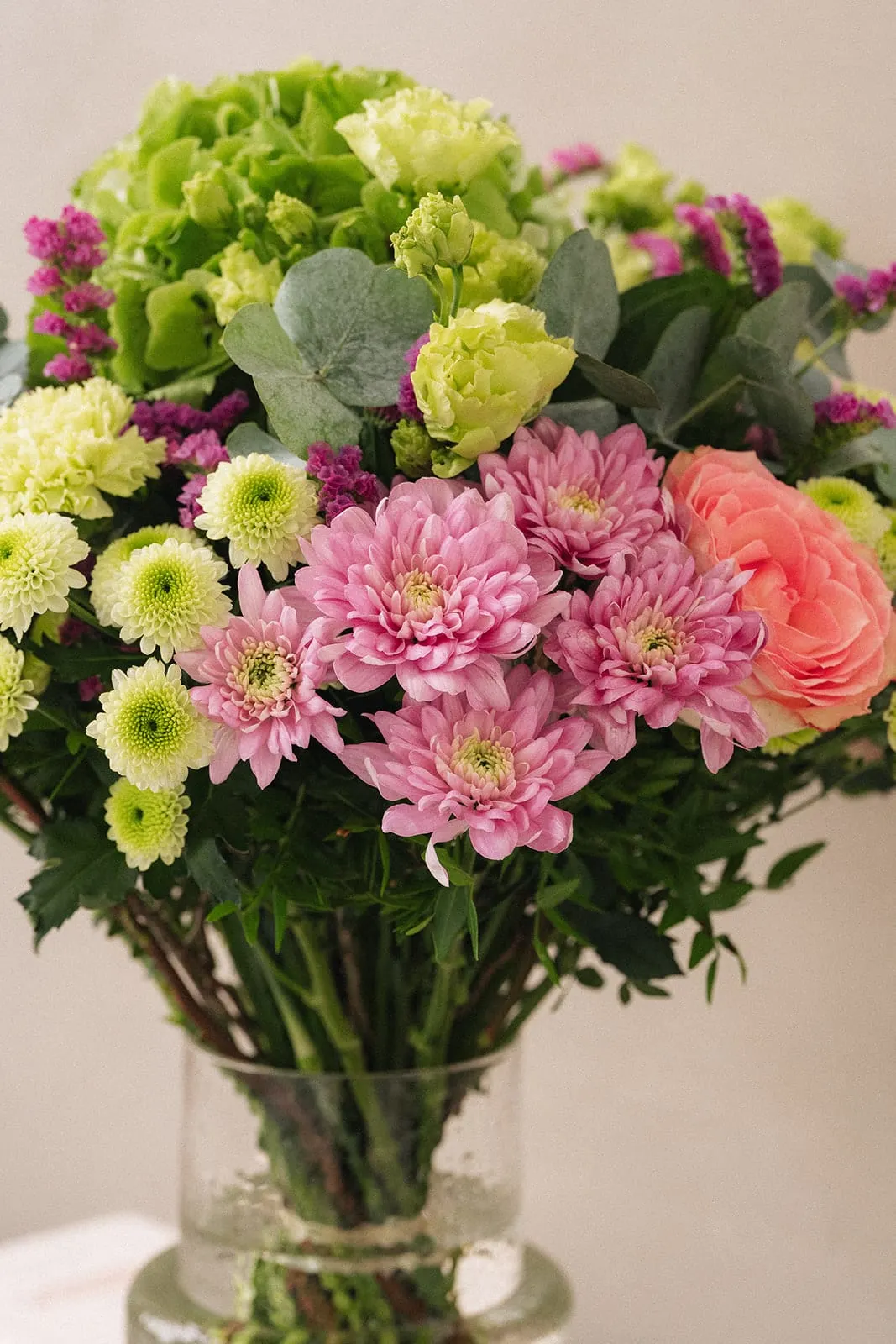 Pink and green bouquet in a clear vase