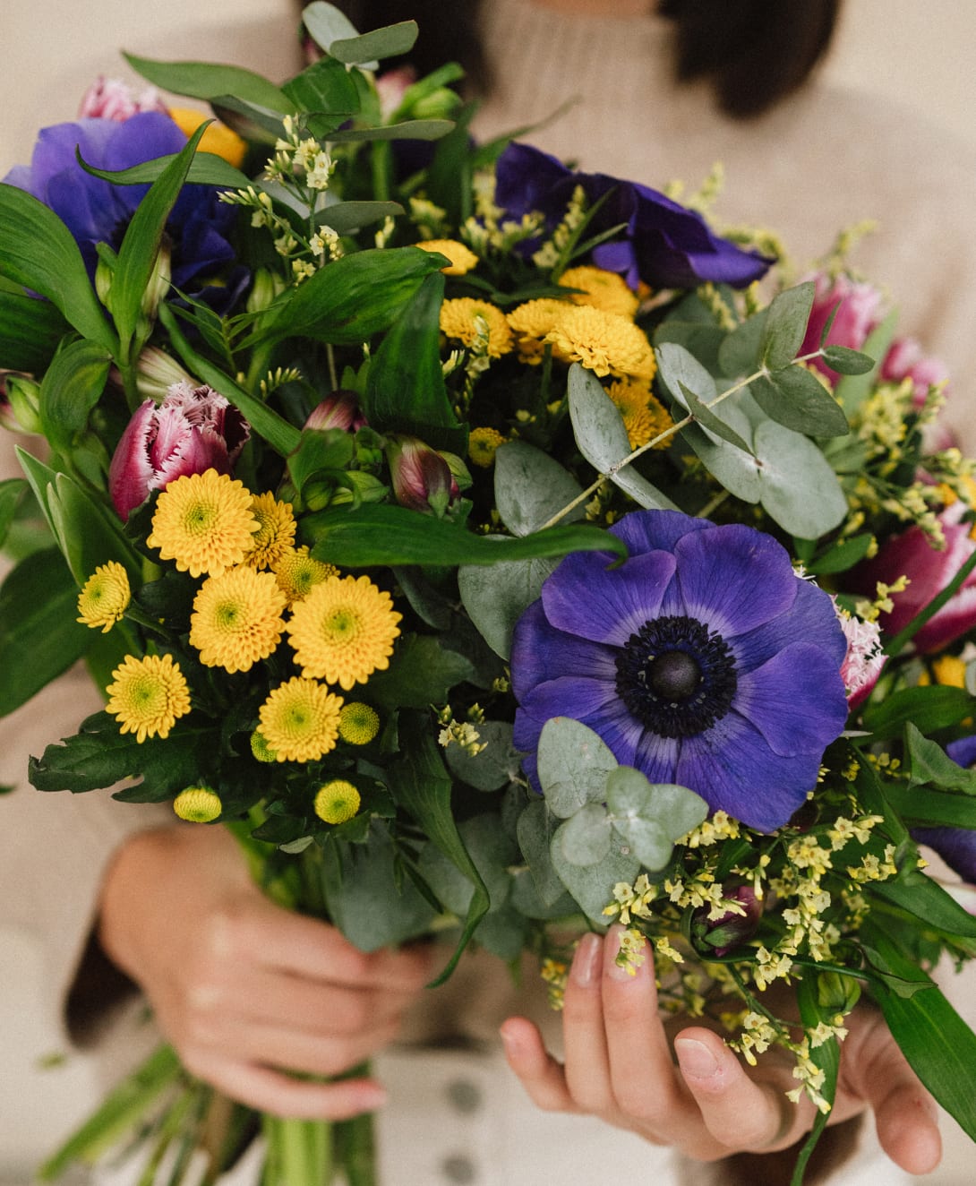 Kanel seasonal flower bouquet held in hand